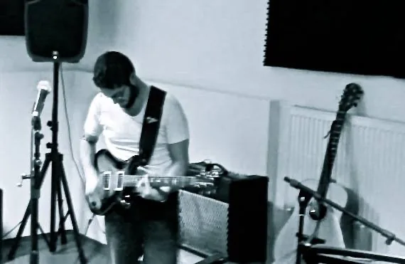 Umberto playing electric guitar in the live room